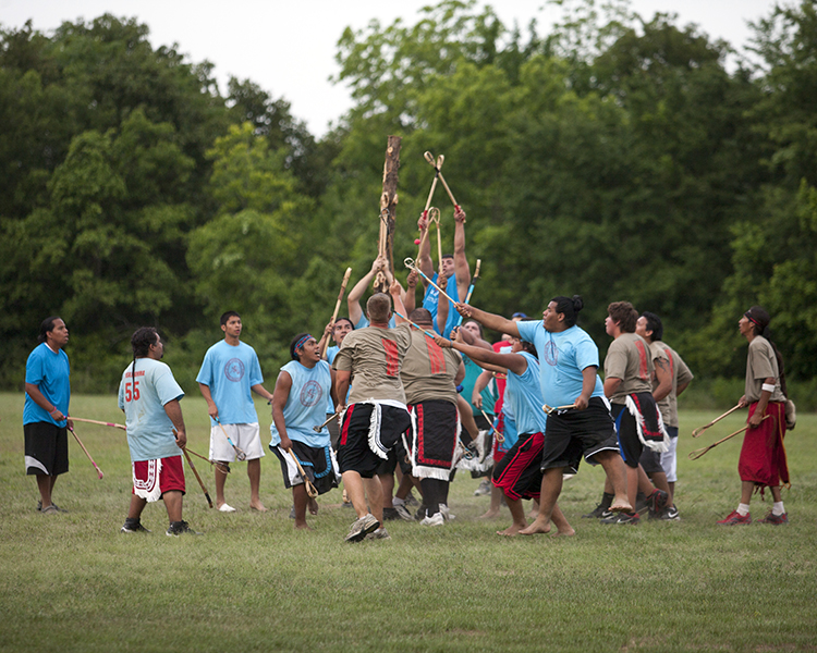 Native American men and boys playing a ball game similar to