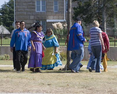 Chickasaws stomp dancing outside